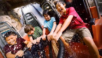 Kids burst into laughter, gripping the boat as a wave splashes them on the thrilling Rapids Expedition ride at Funland Park.