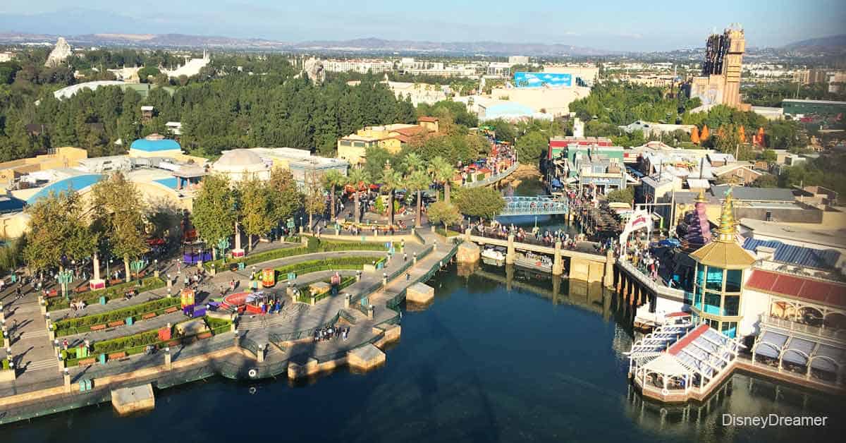 Bird’s-eye view of Universal Studios: thrilling rides, winding waterways, vibrant attractions, and excited crowds everywhere.