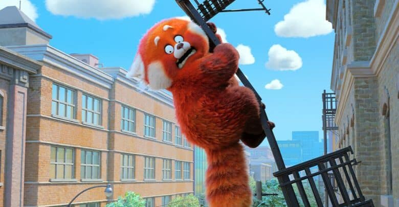Red Panda from Turning Red clings nervously to a city fire escape amid brick buildings and a clear blue sky.
