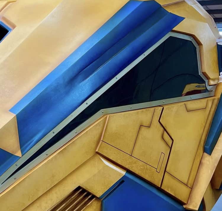 Close-up of vibrant yellow and blue metallic angles from Guardians of the Galaxy: Cosmic Rewind at EPCOT, gleaming in the light.