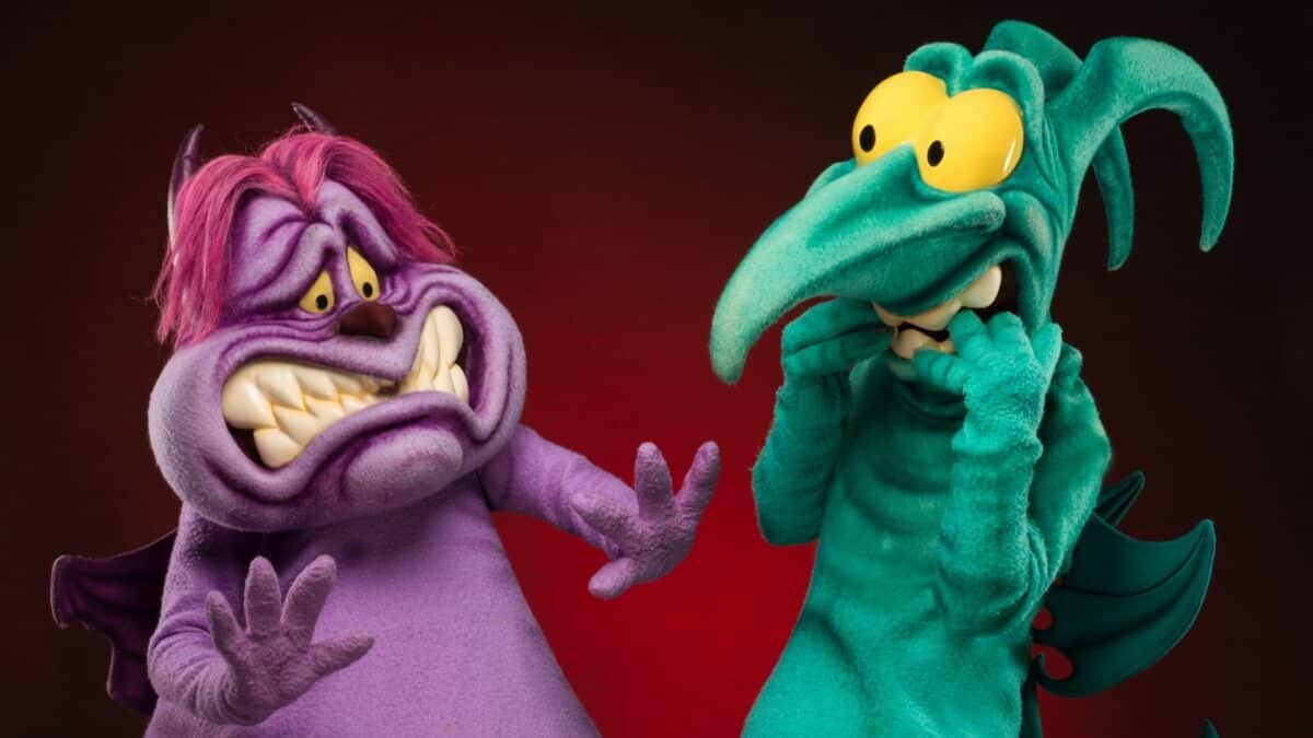 Dr. Facilier and Oogie Boogie pose nervously together at Villains Nite during Disneyland After Dark, in vibrant costumes.