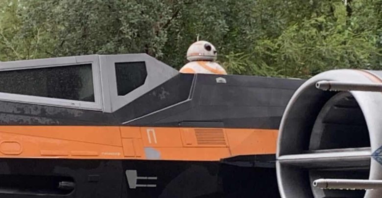 X-wing with BB-8 behind the cockpit, nestled among trees, just like the iconic centerpiece at Star Wars: Galaxy’s Edge.