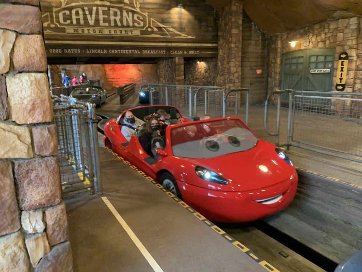 Lightning McQueen ride vehicle cruises along Radiator Springs Racers’ track in Cars Land’s immersive indoor setting at Disneyland.