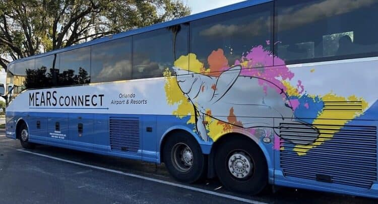 A vibrant Mears Connect bus sporting Orlando Airport & Resorts art, ready to whisk guests to theme parks and resorts.