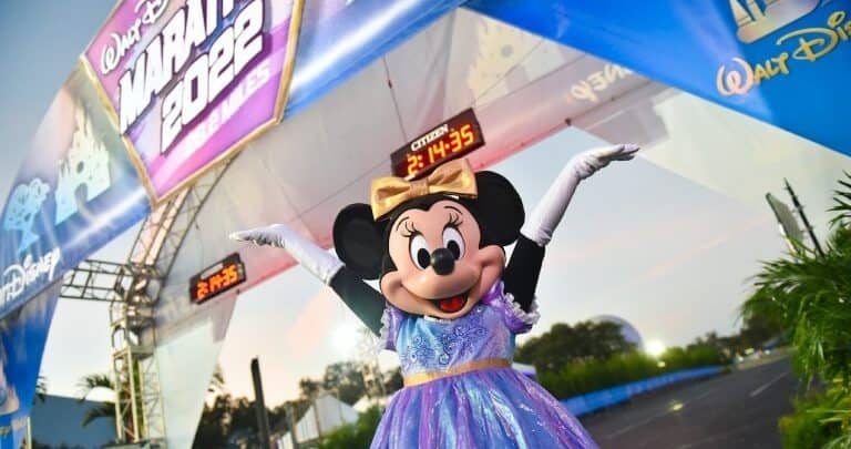 Minnie Mouse dazzles in a purple dress at the Walt Disney Marathon 2022 finish, cheering with athletes and Dopey runners.