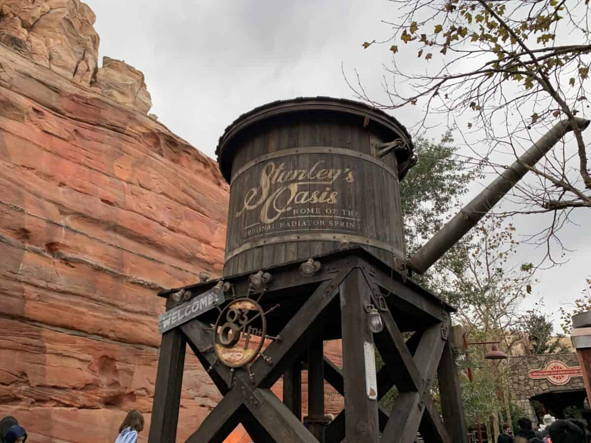 Stanley's Oasis water tower rises amid Cars Land’s red rocks and trees, a special Disneyland Magic Key holder photo location.
