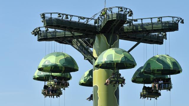 Toy Soldiers Parachute Drop lifts guests sky-high over Disneyland Paris, with green camo theming from Toy Story and blue skies above.
