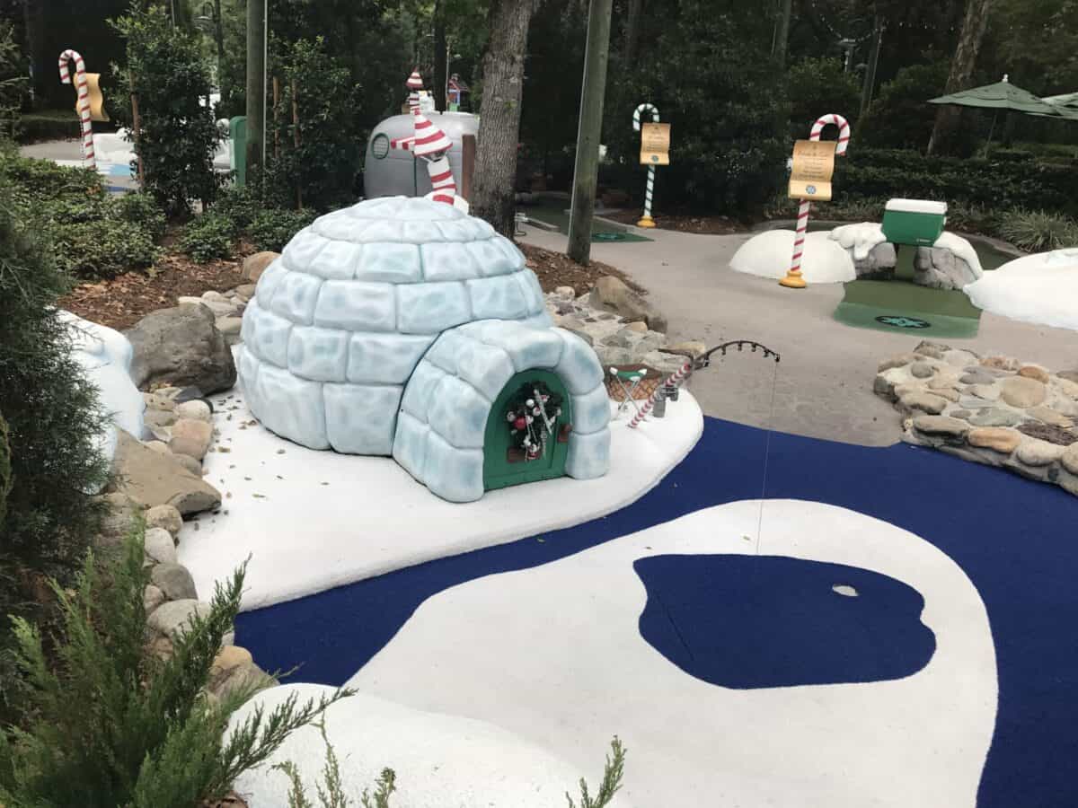 Whimsical winter-themed mini golf in Central Florida with igloo, polar bears, and candy canes nestled in a wooded entertainment zone.