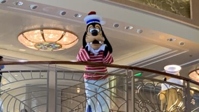 Goofy sports his red and white striped sailor outfit while greeting fans on the ship’s balcony during a Disney Cruise Line event.