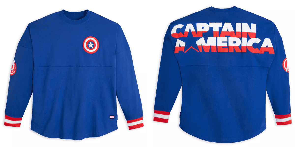 Front and back views of a long-sleeve blue Captain America shirt. Front has a small shield logo on the chest and an emblem on the left sleeve. "Captain America" is printed across the back in large white and red letters, with a star integrated into the design.