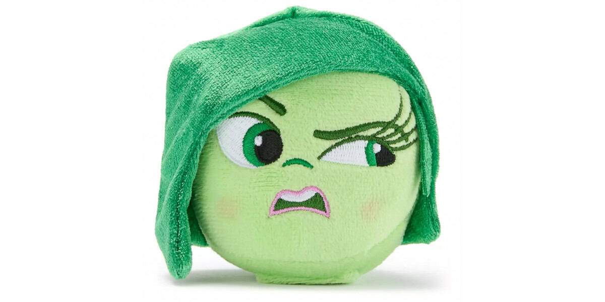 A plush toy with a green face, green hair, and an expressive, disapproving facial expression with raised eyebrows and a frown.