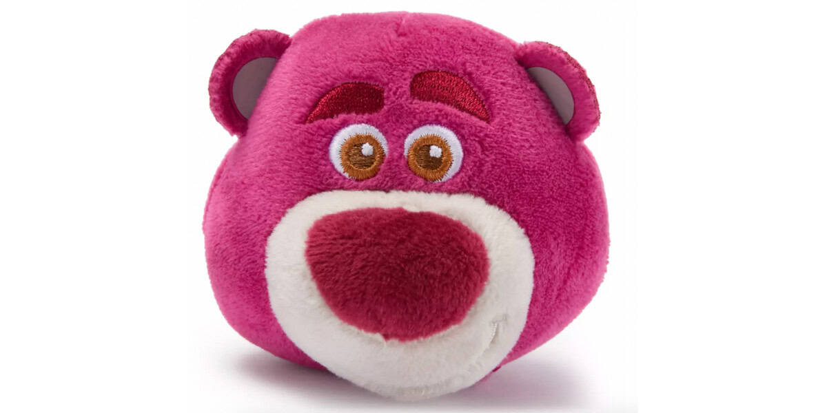 A round, pink plush toy bear with a large red nose, brown eyes, embroidered eyebrows, and a white mouth area, resembling the character Lotso from Toy Story.
