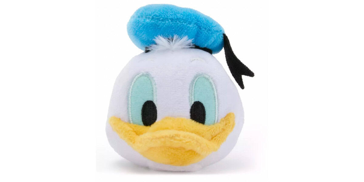 A plush toy of Donald Duck’s face, featuring a blue hat with a black ribbon, blue eyes, a yellow beak, and white plush fabric.