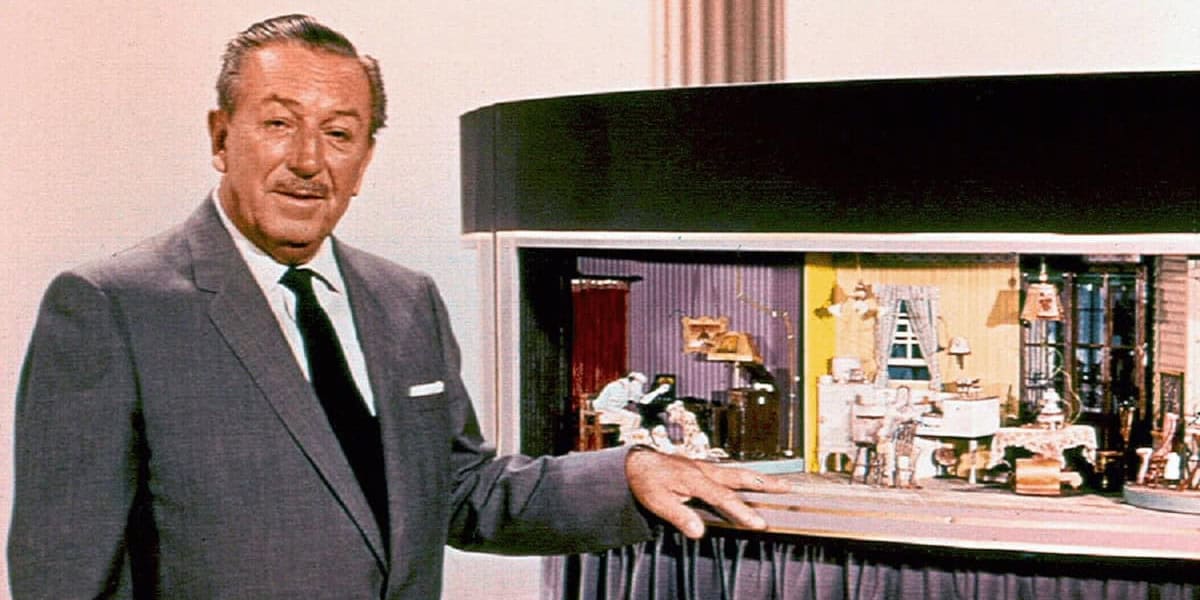 Walt Disney standing next to Carousel of Progress model