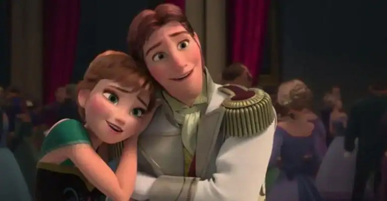 Animated characters Anna and Hans from Disney’s Frozen stand close together at a ball; Anna smiles and rests her head on Hans’s shoulder, while Hans smiles and holds her with his arms crossed. People dance in the background.