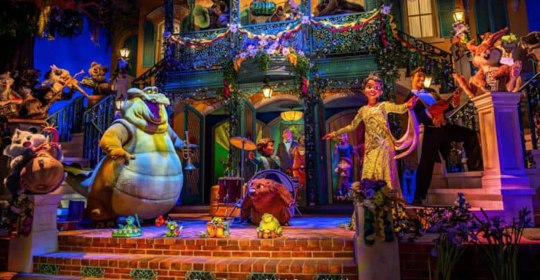 Colorful scene with animated animal characters and people dressed in Mardi Gras attire, performing music and dancing on a decorated, festive porch surrounded by flowers and lights, resembling a lively celebration.