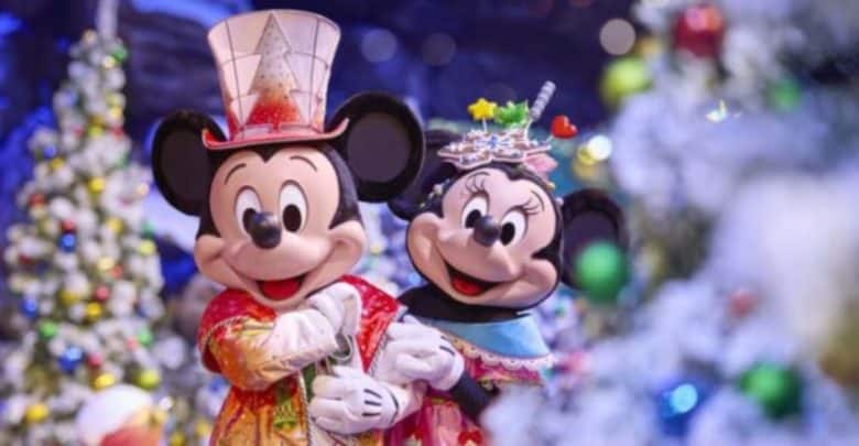Mickey Mouse and Minnie Mouse dressed in festive holiday outfits at Disneyland Paris