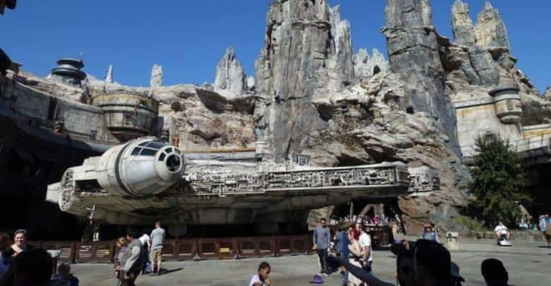 Visitors stroll around the Millennium Falcon at Galaxy's Edge