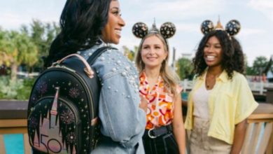 Three women at Disney with one wearing a Loungefly