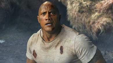 A determined hero in a rugged, torn shirt faces thrilling danger, evoking the excitement of a live Disney action stunt show.