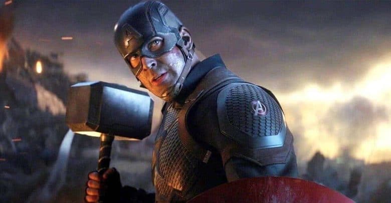 Captain America in a dramatic dark suit wields a hammer and shield on a smoky, fiery stage in an epic Disney Parks show.