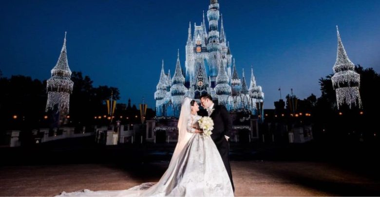 Couple getting married in front of Cinderella Castle