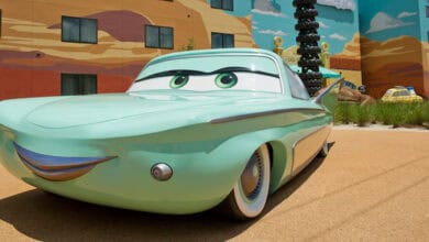 Cars welcomes guests outside a vibrant, cartoon-style building at Disney Resort, adding to the park’s playful charm.