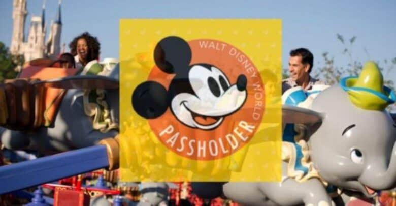 Guests soar on Dumbo the Flying Elephant at Disney World, with a Mickey Mouse Passholder logo featured prominently in the center.