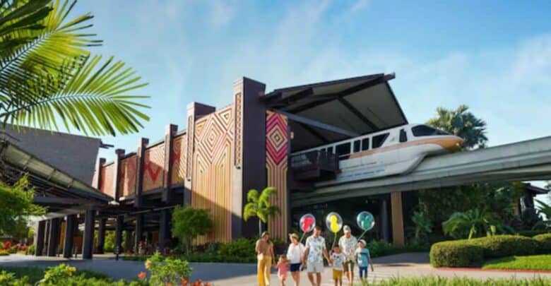 A family walks outside a tropical-themed building with colorful geometric patterns at one of Disney’s Most Expensive Resorts as a monorail passes overhead, surrounded by lush greenery under a blue sky.