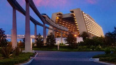 Disney's Contemporary Resort at night with a monorail running through the lobby