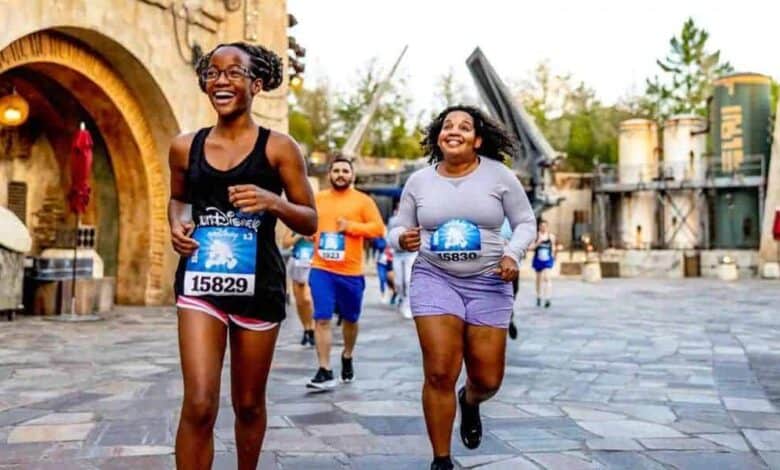 Two runners smiling at the 2027 runDisney Wine & Dine race in Star Wars: Galaxy’s Edge at Disney’s Hollywood Studios.