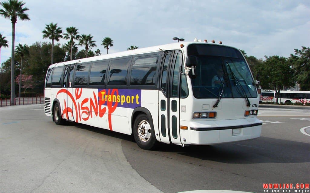 A Walt Disney World bus cruises by palm trees under blue skies, inviting guests to follow bus etiquette for magical park adventures.