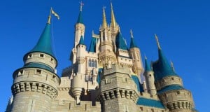 Cinderella Castle shimmering with blue spires and golden trim under a clear sky, the unforgettable icon of Walt Disney World.
