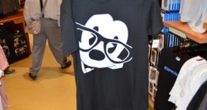 Black tee featuring Mickey Mouse in bold black glasses—ideal park merch for fans hitting Disney World or Disneyland this season.