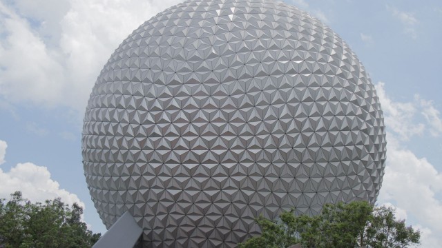 Spaceship Earth dominates Epcot, framed by lush trees and blue skies—a must-see landmark for every Disney World fan.