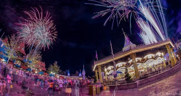 Vibrant fireworks dazzle above Magic Kingdom’s glowing carousel, capturing classic Disney World magic and crowd excitement.