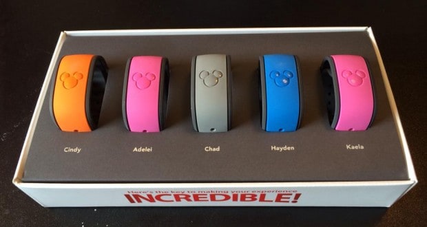 Five vibrant MagicBands labeled Cindy, Adelei, Chad, Hayden, and Kaela await in a box—ready for Disney World fun!.