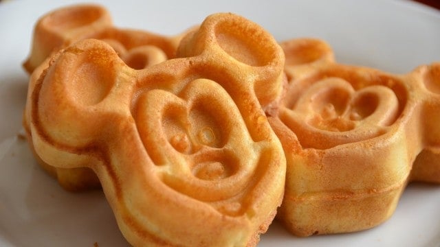 Mickey-shaped golden waffles on a white plate—a magical Disney World breakfast to kick off your day in the park.