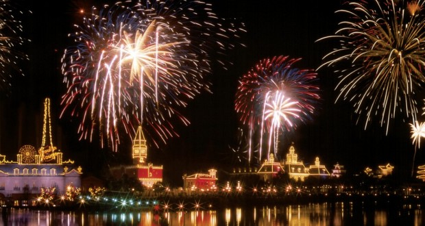 Vibrant fireworks dazzle over Disney World’s glowing attractions, their reflections shimmering in the calm lake beneath the night sky.