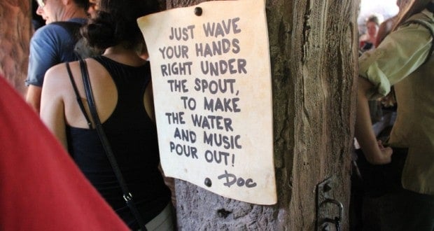At Walt Disney World's interactive queue, a sign reads: "Wave your hands under the spout for water and music! – Doc.