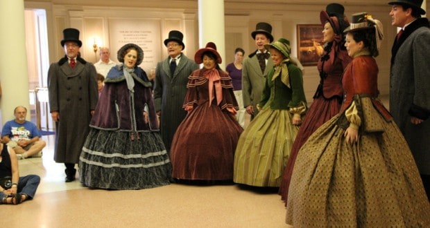 Victorian carolers perform inside Epcot as guests watch—an enchanting seasonal highlight at Walt Disney World.