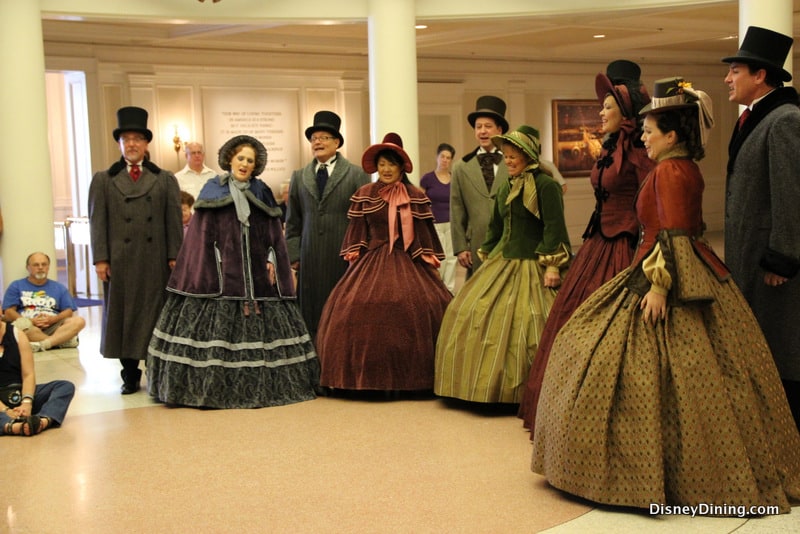 Victorian carolers perform inside Epcot as guests watch—an enchanting seasonal highlight at Walt Disney World.