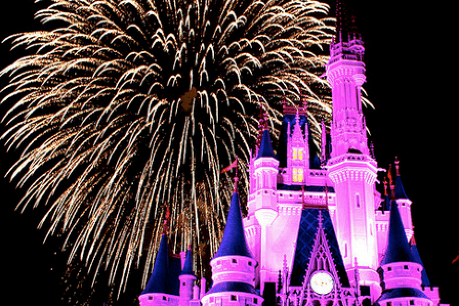 Cinderella Castle glows pink as dazzling golden fireworks light up the night sky at Disney World, thrilling the crowd below.