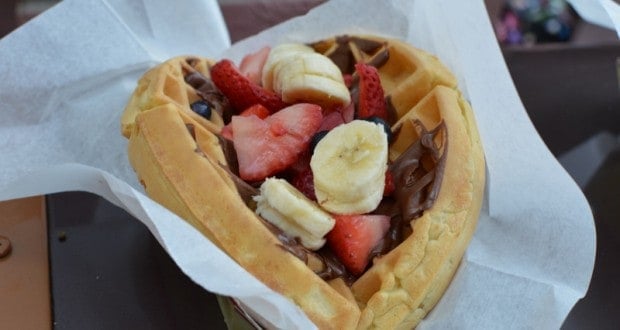 A heart-shaped waffle with Nutella, bananas, and strawberries—just like a sweet treat from Main Street at Disney Parks.