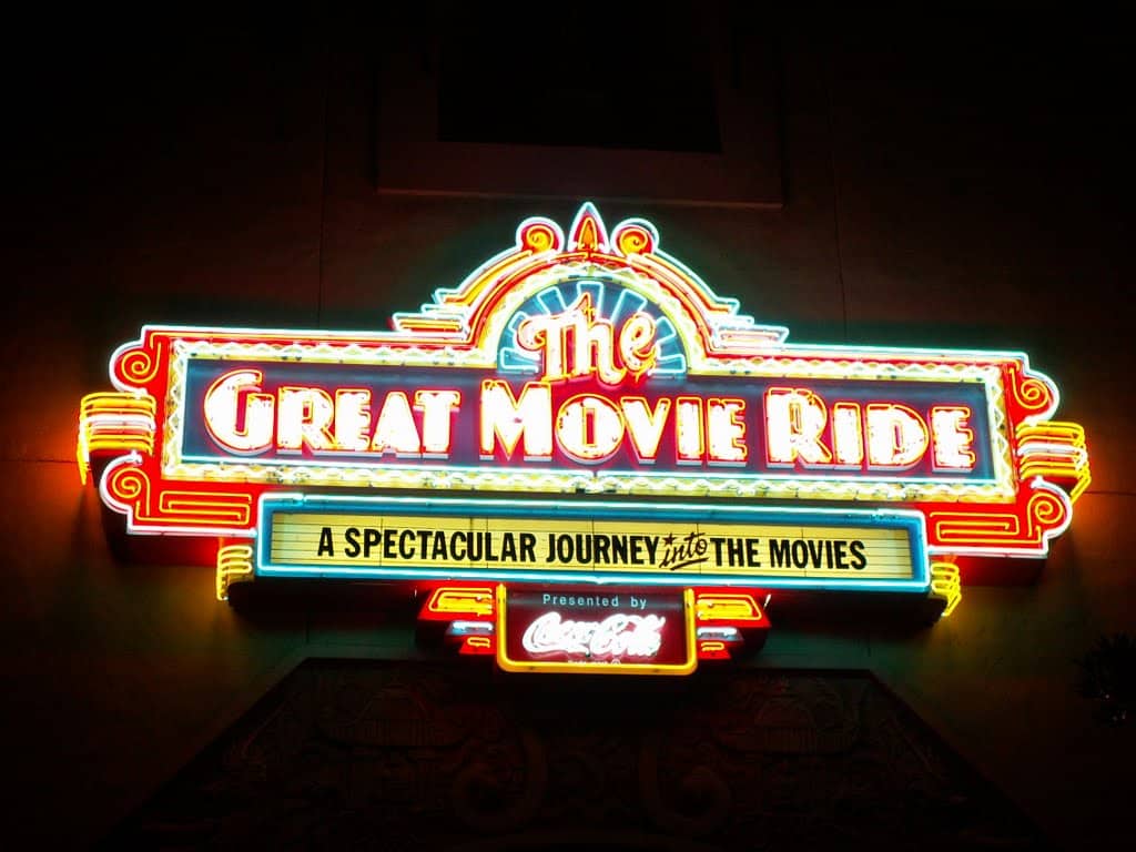 Bright neon "The Great Movie Ride" sign at Walt Disney World beckons guests: "A spectacular journey into the movies.