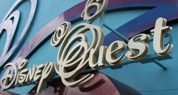 Disney Quest marquee against a blue wall and energetic abstract shapes, evoking the lively spirit of Downtown Disney pre-closure.
