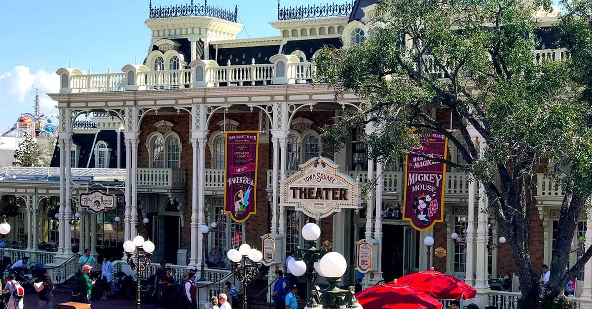 Main Street’s ornate Victorian theater at Magic Kingdom, decked in bright banners, welcomes crowds of excited Disney guests.