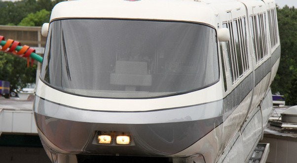 A sleek Disney World monorail glides above the treetops, capturing the magic of a perfect park day winding to a close.