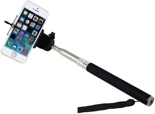 A smartphone on a black selfie stick with a wrist strap, showing its home screen—selfie sticks are not allowed at Disney World.