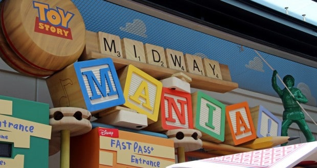 Toy Story Midway Mania entrance at Disney World, with playful block signage and a green army man, invites guests to this fan-favorite ride.